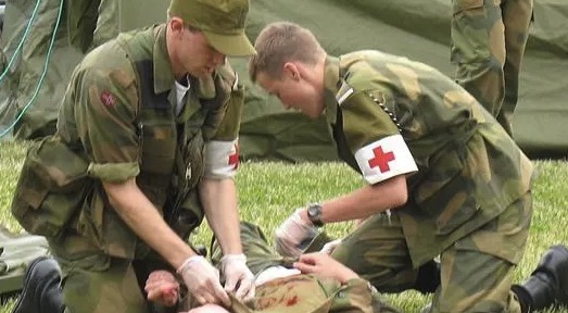 How should a gunshot wound be treated?