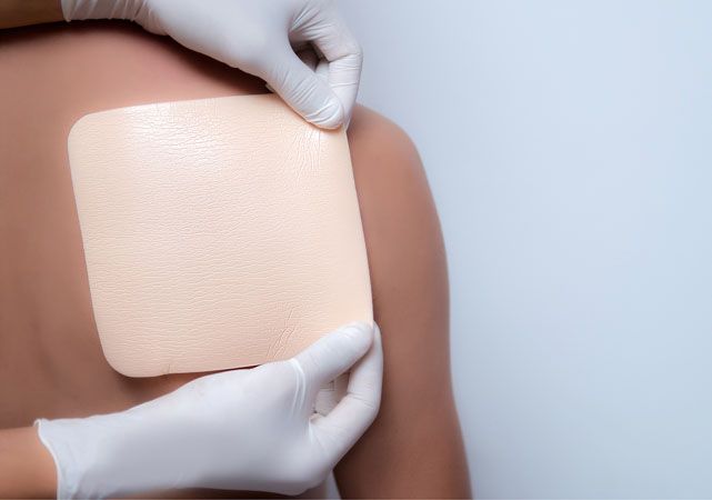 What type of dressing should be used for wound care on sensitive skin?