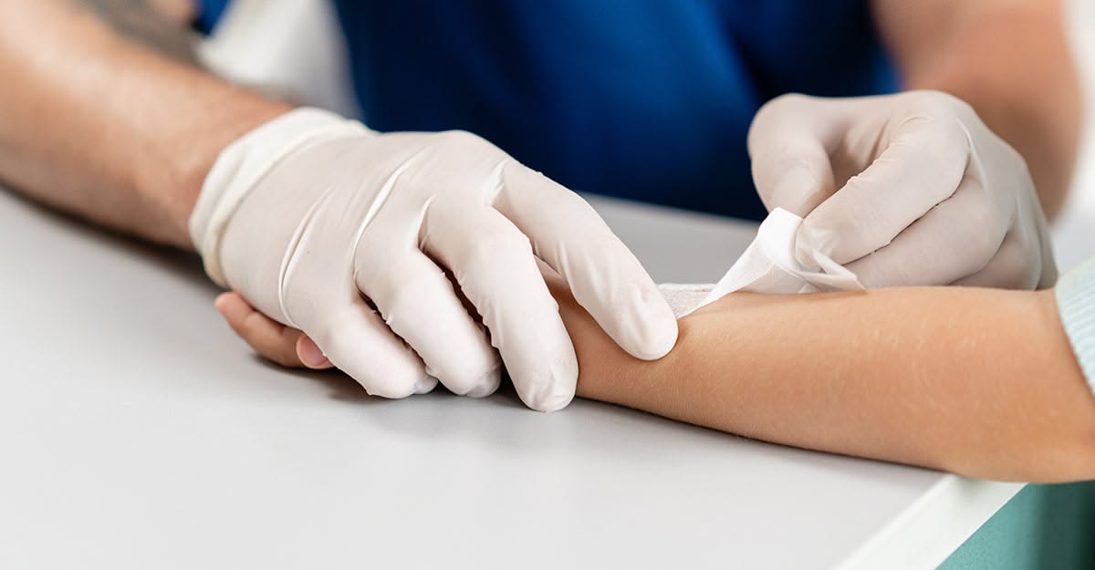 How should dressings be applied to patients whose skin is as thin as paper?